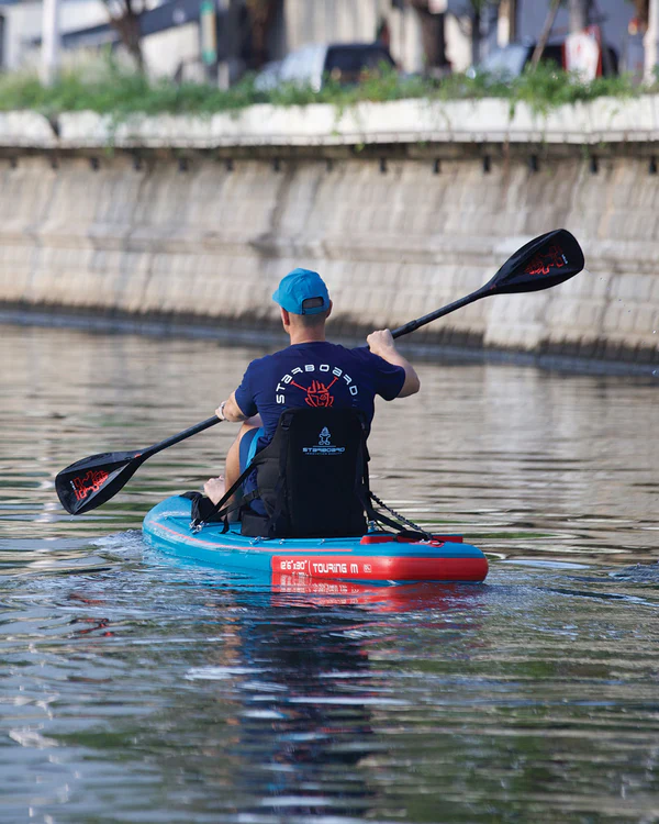 Inflatable touring board setup with kayak seat and footrest